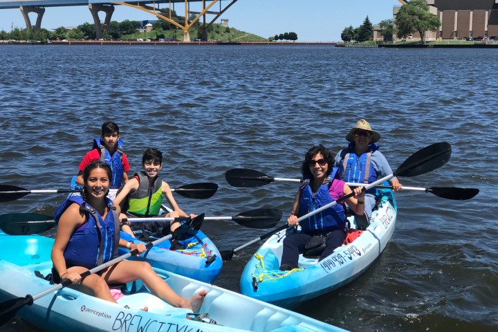 A family in their kayaks on Lake Michigan