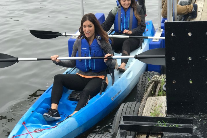 A couple getting ready on a double kayak