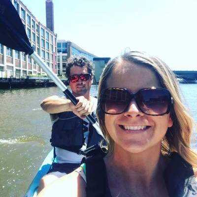 A couple smiling on a double kayak