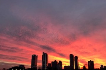 A pink sunset behind the city skyline
