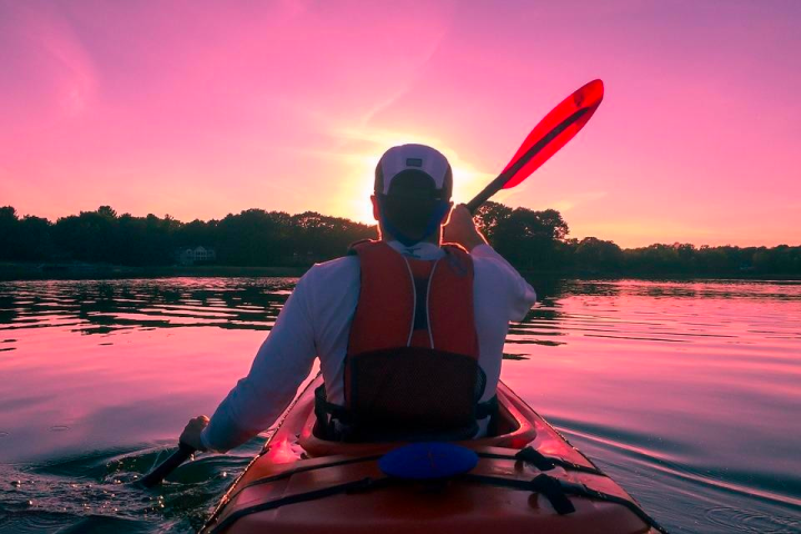 a person sitting in front of a body of water